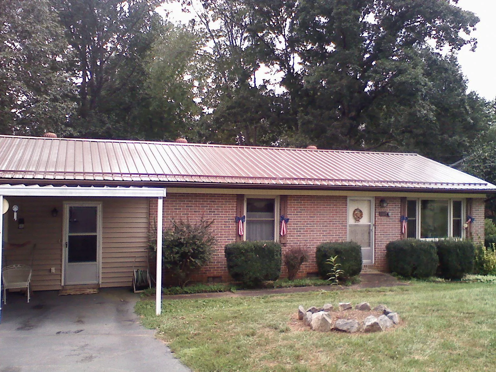 Bronze metal roof and carport on a brick ranch home — Roof Repair work by our crew in Sewickley